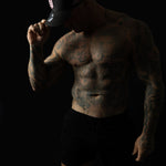 Model wearing black and pink sweat-resistant snapback cap left view – Shred Cartel Elite Series