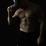 Model wearing black and pink sweat-resistant snapback cap left view – Shred Cartel Elite Series