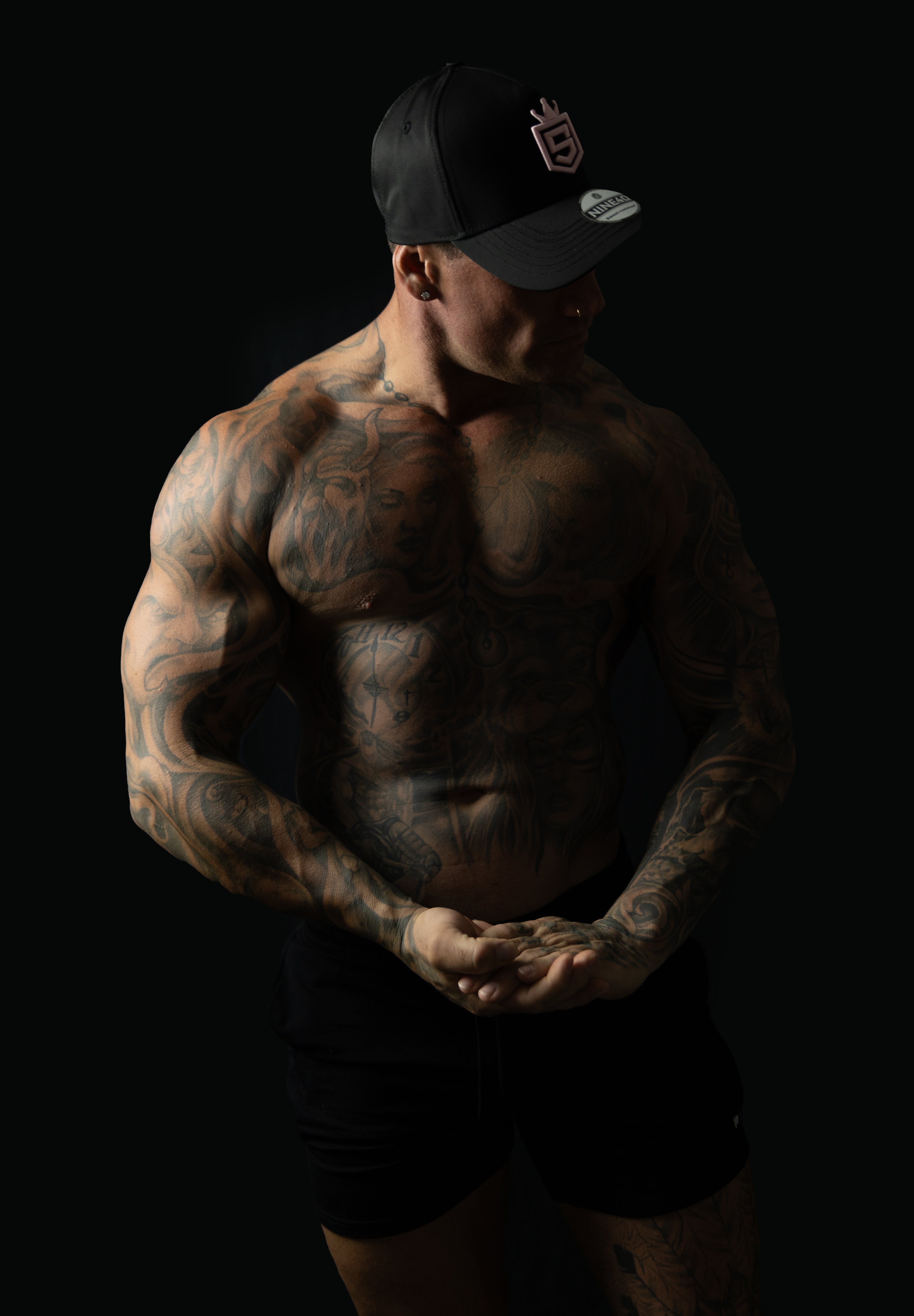 Model wearing black and pink sweat-resistant snapback cap side view – Shred Cartel Elite Series