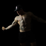Model wearing black and pink sweat-resistant snapback cap front view – Shred Cartel Elite Series