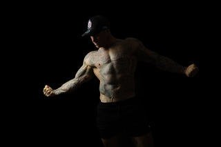 Model wearing black and pink sweat-resistant snapback cap front view – Shred Cartel Elite Series